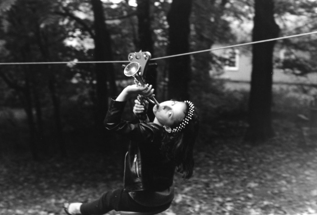 black white photo girl trumpet